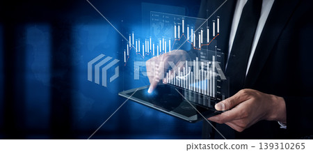 Professional Man in Suit Using Tablet to Analyze Financial Data and Stock Market Trends with Digital Graphs and Charts Represented as Holographic Images Scalp 139310265