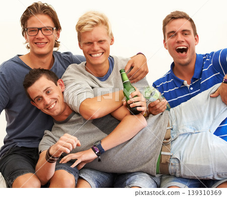 Friends, portrait and drinking beer at festival with celebration, happy and comedy with laughter at party. Young men, group or drunk with alcohol for relax holiday, social fun or concert for bonding Friends, portrait and drinking beer at festival with celebration, happy and comedy with laughter at party. Young men, group or drunk with alcohol for relax holiday, social fun or concert for bonding 139310369