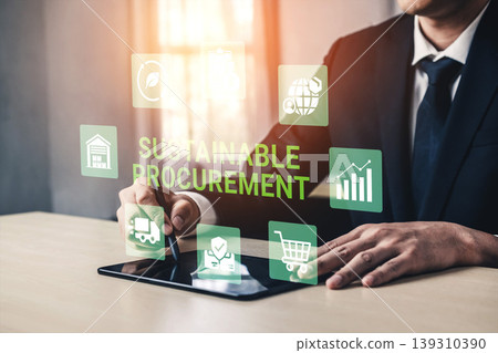 Professional Businessman Engaging in Sustainable Procurement Strategy Using Digital Tablet with Various Icons and Graphics Representing Eco-Friendly Practices Ledger 139310390