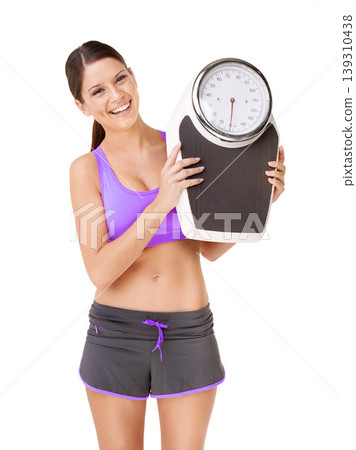 Scale, portrait and happy woman with exercise, weight loss and smile from health progress. Workout, fitness and sport training of a female person in studio with white background and wellness care Scale, portrait and happy woman with exercise, weight loss and smile from health progress. Workout, fitness and sport training of a female person in studio with white background and wellness care 139310438