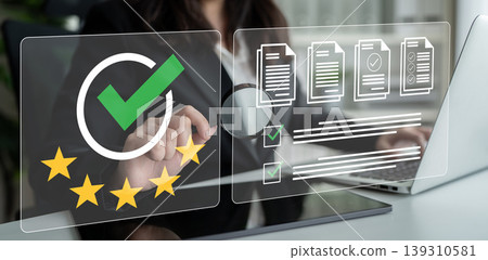 Businessperson Using Digital Technology for Document Verification and Quality Assessment in Office Environment with Checkmarks and Stars Ledger 139310581