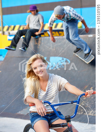 Happy, friends and portrait of teenager at skatepark in summer on vacation or holiday with adventure. Girl, bicycle or boys on ramp with skateboard or smile for challenge or ride on concrete in city Happy, friends and portrait of teenager at skatepark in summer on vacation or holiday with adventure. Girl, bicycle or boys on ramp with skateboard or smile for challenge or ride on concrete in city 139310595