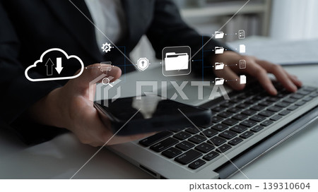 Professional Business Person Using Mobile Phone and Laptop for Cloud Data Management and File Storage Visualization in Modern Office Quark Professional Business Person Using Mobile Phone and Laptop for Cloud Data Management and File Storage Visualization in Modern Office Quark 139310604