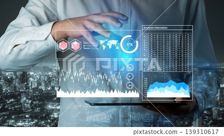 Business Professional Using Innovative Technology for Data Analysis Overlooking City Skyline at Night with Digital Graphs and Charts Gluon Business Professional Using Innovative Technology for Data Analysis Overlooking City Skyline at Night with Digital Graphs and Charts Gluon 139310617