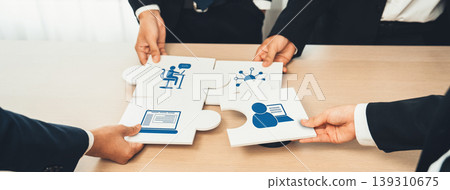 Diverse Business Professionals Collaborating on Puzzle Pieces, Symbolizing Teamwork and Strategy in Modern Office Environment. Amity 139310675