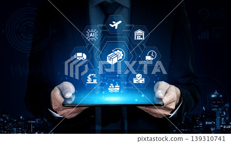Businessman Using Tablet for Digital Supply Chain Management with Various Icons Representing Logistics and Technology Ledger Businessman Using Tablet for Digital Supply Chain Management with Various Icons Representing Logistics and Technology Ledger 139310741