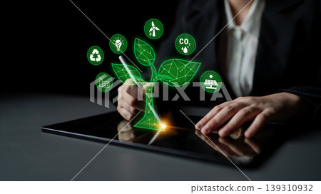 Digital Innovation in Sustainable Development with Green Technology Symbols and Hands Engaging on a Tablet Device for Eco-Friendly Solutions Quark 139310932