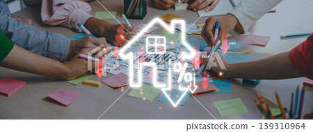 A dynamic workspace showcasing a collaborative brainstorming session with hands engaged in planning real estate concepts using sticky notes and a house icon symbolizing market trends. Sigmoid A dynamic workspace showcasing a collaborative brainstorming session with hands engaged in planning real estate concepts using sticky notes and a house icon symbolizing market trends. Sigmoid 139310964