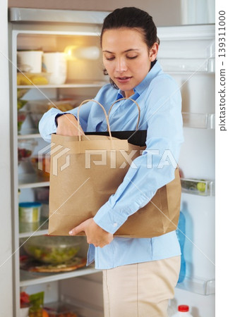 Woman, groceries and bag for packing in fridge with idea for organization of food, fruit or vegetables for diet. Female person, think and meal for nutrition, vegan and recipe with produce in home Woman, groceries and bag for packing in fridge with idea for organization of food, fruit or vegetables for diet. Female person, think and meal for nutrition, vegan and recipe with produce in home 139311000