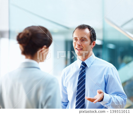 Collaboration, office and business people in discussion for meeting, conversation and talking. Corporate lawyers, company and man and woman chat for project advice, working together and teamwork 139311011