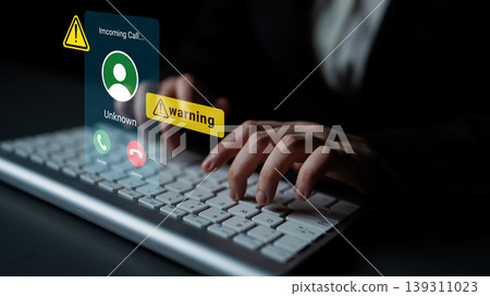 Alert Notification of Incoming Call with Warning Symbol Displayed on a Computer Screen While Hands Type on Keyboard Gantry Alert Notification of Incoming Call with Warning Symbol Displayed on a Computer Screen While Hands Type on Keyboard Gantry 139311023