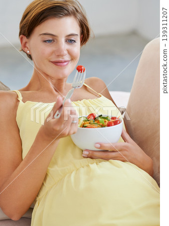 Pregnant woman, salad and smile on sofa for health, nutrition and wellness in living room of apartment. Person, vegetables or happy on couch of lounge for relax, pregnancy and healthy diet with fiber Pregnant woman, salad and smile on sofa for health, nutrition and wellness in living room of apartment. Person, vegetables or happy on couch of lounge for relax, pregnancy and healthy diet with fiber 139311207