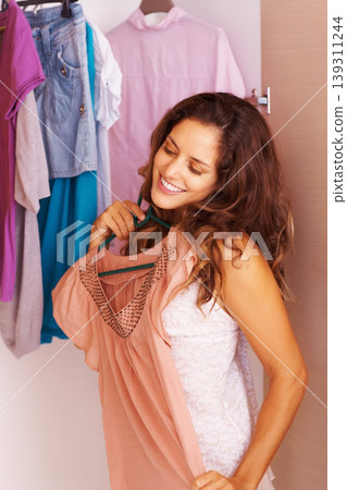 Woman, clothes and choice or happy in closet with morning routine, decision and outfit selection in bedroom of home. Person, face or smile with searching, style or clothing for fashion from wardrobe Woman, clothes and choice or happy in closet with morning routine, decision and outfit selection in bedroom of home. Person, face or smile with searching, style or clothing for fashion from wardrobe 139311244