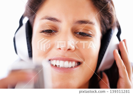 Headphones, music player and woman face listening to playlist track, audio podcast or wellness sound. Closeup, tech and relax girl reading, scroll or choice for media, song or radio streaming app 139311281
