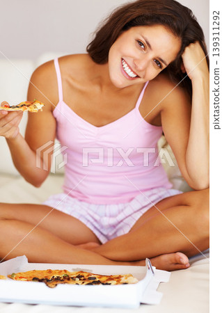Smile, eating and portrait of woman with pizza on bed for dinner, supper or lunch on weekend at home. Happy, meal and female person from Canada in pajamas enjoying fast food in bedroom at apartment. Smile, eating and portrait of woman with pizza on bed for dinner, supper or lunch on weekend at home. Happy, meal and female person from Canada in pajamas enjoying fast food in bedroom at apartment. 139311292