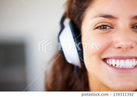 Smile, headphones and half face of woman listening to music, playlist or radio at home. Happy, technology and portrait of female person from Canada relax and streaming song or album in her apartment. 139311392