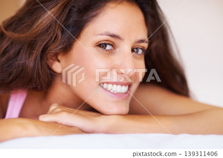 Smile, portrait and face of young woman relaxing on bed on a weekend morning at modern home. Happy, beautiful and female person with positive, good and confident attitude in bedroom at house. 139311406