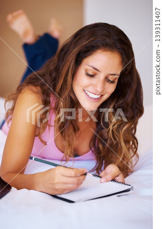 Young, woman and writing in diary in bedroom with idea for vision of future. Female person, student or creative by notebook for journaling, goals or aspiration in home for peace, wellness or relaxing 139311407