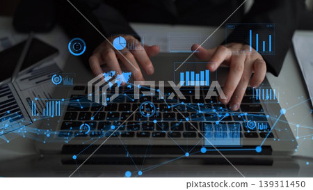 Business professional typing on keyboard with digital analytics overlay, showcasing technology and data analysis in a modern workspace environment xenic Business professional typing on keyboard with digital analytics overlay, showcasing technology and data analysis in a modern workspace environment xenic 139311450