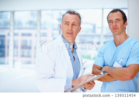 Doctors, men and clipboard in hospital together for thinking, space and vision for medical info. Medic team, partnership and checklist for wellness, healthcare or idea for problem solving at clinic Doctors, men and clipboard in hospital together for thinking, space and vision for medical info. Medic team, partnership and checklist for wellness, healthcare or idea for problem solving at clinic 139311454