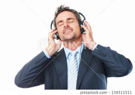 Businessman, headphones and relaxing to music, streaming radio and audio or song, chill on break. Male person, connection and dance to album, podcast and sound at studio, peace and white background Businessman, headphones and relaxing to music, streaming radio and audio or song, chill on break. Male person, connection and dance to album, podcast and sound at studio, peace and white background 139311511