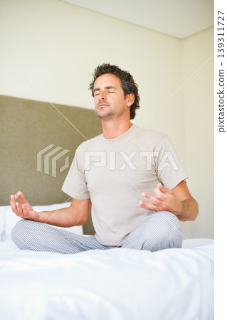 Lotus hands, yoga pose and man on bed with meditation, peace and mental health wellness in his home. Breathing, balance and male person relax in bedroom with spiritual, healing or holistic self care Lotus hands, yoga pose and man on bed with meditation, peace and mental health wellness in his home. Breathing, balance and male person relax in bedroom with spiritual, healing or holistic self care 139311727