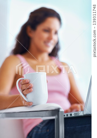 Coffee, home and woman typing on laptop for remote working, freelance career and relax on break. Happy, morning and person on computer with warm beverage for internet, website research and blog Coffee, home and woman typing on laptop for remote working, freelance career and relax on break. Happy, morning and person on computer with warm beverage for internet, website research and blog 139311748