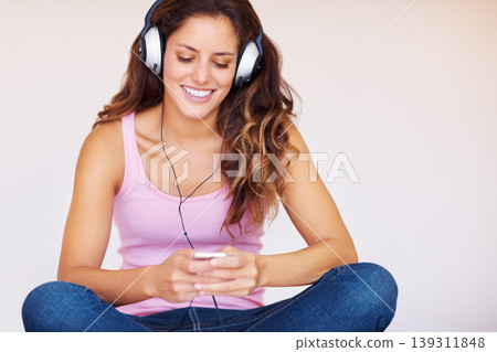 Smile, headphones and young woman on bed listening to music, playlist or radio at home. Happy, technology and face of female person from Canada relax in bedroom and stream song or album in apartment Smile, headphones and young woman on bed listening to music, playlist or radio at home. Happy, technology and face of female person from Canada relax in bedroom and stream song or album in apartment 139311848