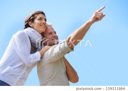 Happy, couple and outdoor pointing to sky, together with love and happiness on adventure in summer. Vacation, travel and woman hug mature man sightseeing on holiday with mockup, space or background Happy, couple and outdoor pointing to sky, together with love and happiness on adventure in summer. Vacation, travel and woman hug mature man sightseeing on holiday with mockup, space or background 139311864
