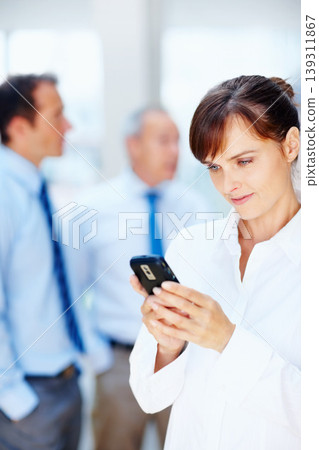 Business people, typing and woman with a smartphone, connection and internet with team, contact and deadline. Person, employee or agent with cellphone, mobile user and digital app with online reading 139311867