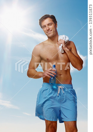 Portrait, towel and man with water for fitness, sport workout or wellness exercise outdoor in summer on blue sky. Smile, drink bottle and hydration of shirtless person, healthy body muscle and abs Portrait, towel and man with water for fitness, sport workout or wellness exercise outdoor in summer on blue sky. Smile, drink bottle and hydration of shirtless person, healthy body muscle and abs 139311873