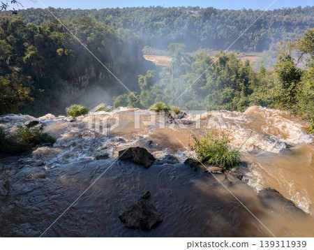 A backdrop of rocks and a rushing river in front of Iguazu Falls in Iguazu National Park and Reserve in Argentina in June 139311939