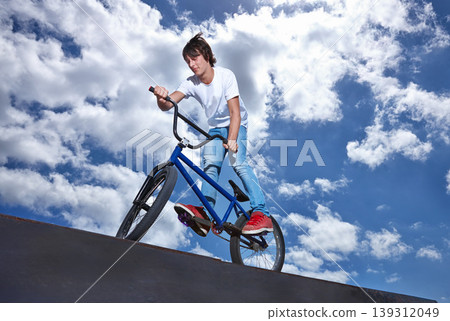 Ride, ramp and man with bike at park, event or competition for sport with risk, energy and freedom. Mockup, space or person in performance of stunt trick on bicycle for fun in summer with adventure Ride, ramp and man with bike at park, event or competition for sport with risk, energy and freedom. Mockup, space or person in performance of stunt trick on bicycle for fun in summer with adventure 139312049