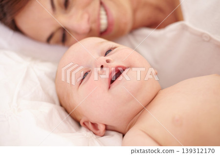 Mother, baby and happiness or love, care and relaxing on bed, bonding and joy in parenthood. Mom, newborn and peace or calm at home, positive and happy for child development, smile and rest together 139312170