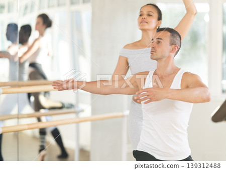 Young man and young woman rehearsing pair ballet 139312488
