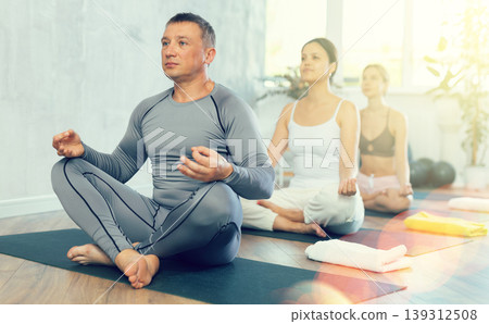 Meditation of group of sports people of different nationalities in yoga class 139312508