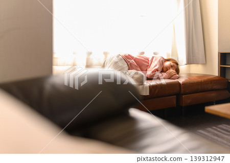 Young woman sleeping on the couch Young woman sleeping on the couch 139312947