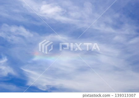 The sun shining through the clouds and the sky filled with iridescent clouds. The sun shining through the clouds and the sky filled with iridescent clouds. 139313307