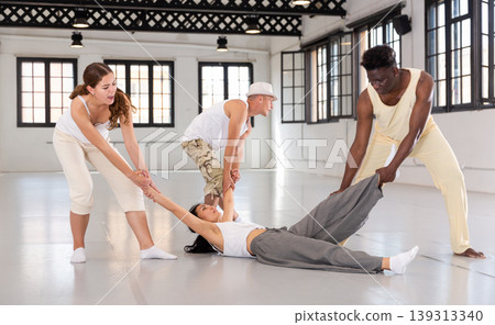 Dancers on stage, choreography with elements of theatrical production Dancers on stage, choreography with elements of theatrical production 139313340