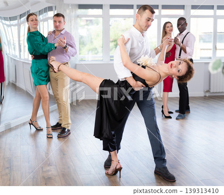 Woman and young man practicing waltz in dancing studio Woman and young man practicing waltz in dancing studio 139313410