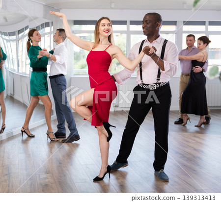Man and young woman practicing waltz in dancing studio 139313413