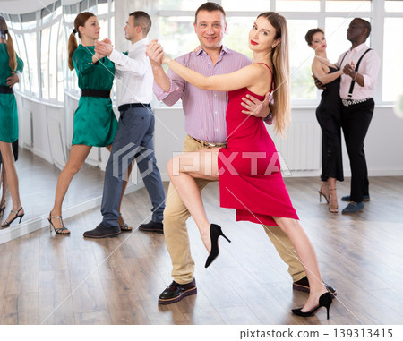Man and young woman practicing waltz in dancing studio 139313415