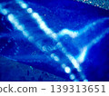 A fantastically shimmering blue light bokeh and an abstract, sparkling background. 139313651