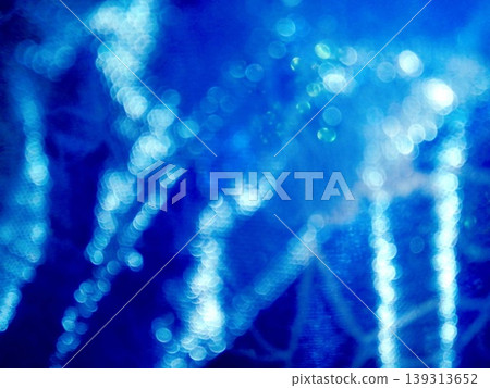 A fantastically shimmering blue light bokeh and an abstract, sparkling background. A fantastically shimmering blue light bokeh and an abstract, sparkling background. 139313652