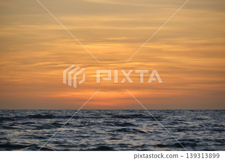 Dramatic red ocean waves at sunset with soft evening sea dark water Dramatic red ocean waves at sunset with soft evening sea dark water 139313899