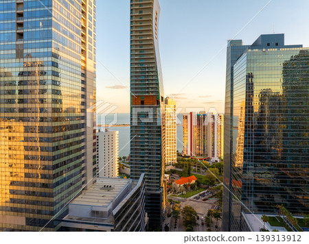 Downtown district of Miami in Florida, USA. Urban landscape of high skyscraper buildings in modern American city at sunset Downtown district of Miami in Florida, USA. Urban landscape of high skyscraper buildings in modern American city at sunset 139313912