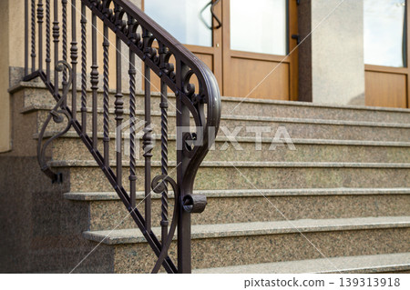 Detail of a house facade. New granite stairs with metal railings. Detail of a house facade. New granite stairs with metal railings. 139313918