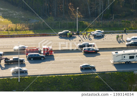 Damaged cars in severe traffic accident on American interstate highway road. 139314034