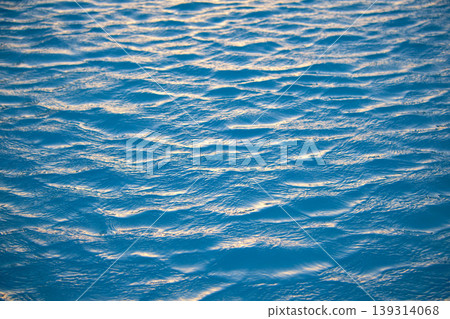 Closeup seascape surface of blue sea water with small ripple waves. Closeup seascape surface of blue sea water with small ripple waves. 139314068