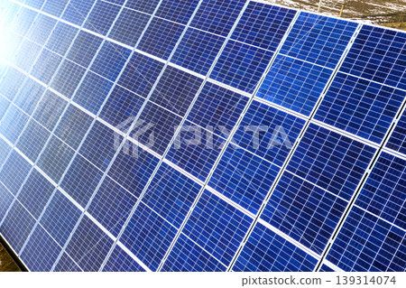 Close-up surface of lit by sun blue shiny solar photo voltaic panels system on building roof. Renewable ecological green energy production concept. 139314074